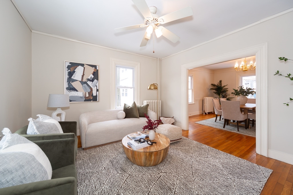 13 Union Street, Unit 13 Needham, MA 02494 - Photo 2 of 19 a living room with furniture and a chandelier