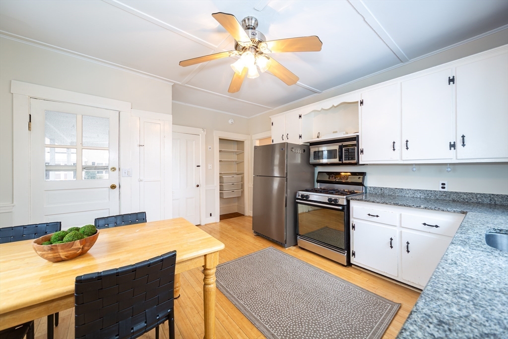13 Union Street, Unit 13 Needham, MA 02494 - Photo 7 of 19 a kitchen with stainless steel appliances granite countertop a sink a stove and a refrigerator