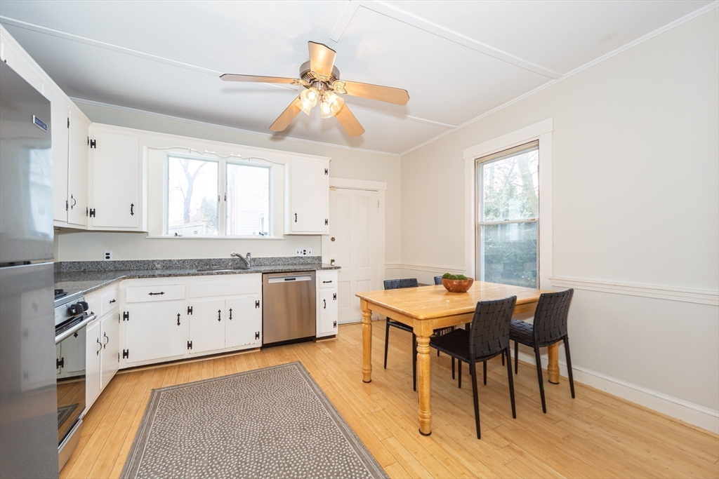 13 Union Street, Unit 13 Needham, MA 02494 - Photo 8 of 19 a kitchen with granite countertop cabinets a dining table and chairs