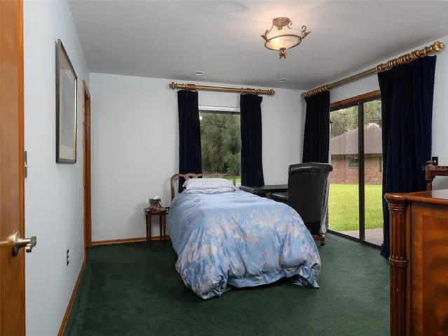 a bathroom with a granite countertop toilet sink and mirror