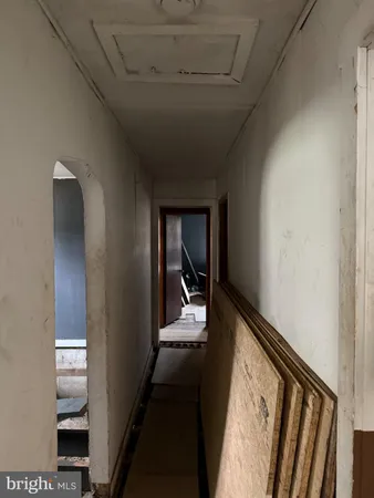 a view of a hallway with wooden floor and workspace