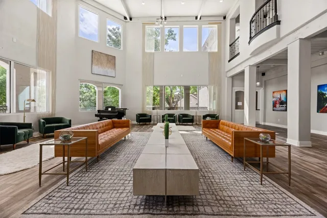 a living room with furniture rug and a chandelier