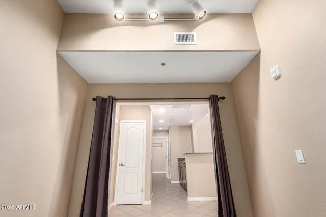 an empty room with windows and fan