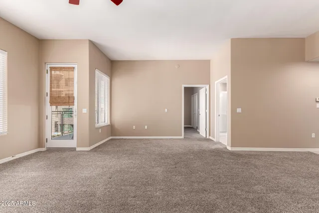 a view of a livingroom with a ceiling fan and window