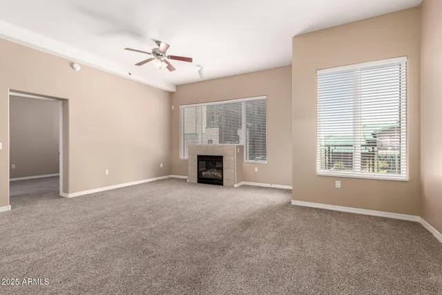 a view of a livingroom with a stove and a ceiling fan