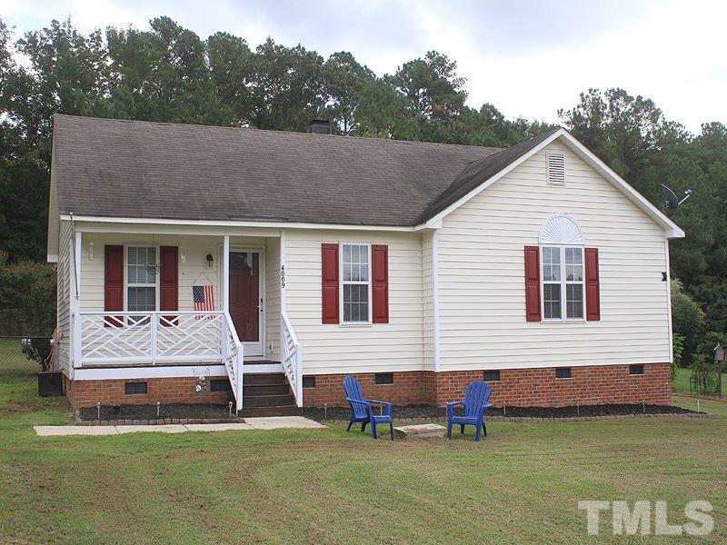 4009 Rockside Hills Drive Raleigh, NC 27603 - Photo 1 of 25 a front view of house with yard and green space