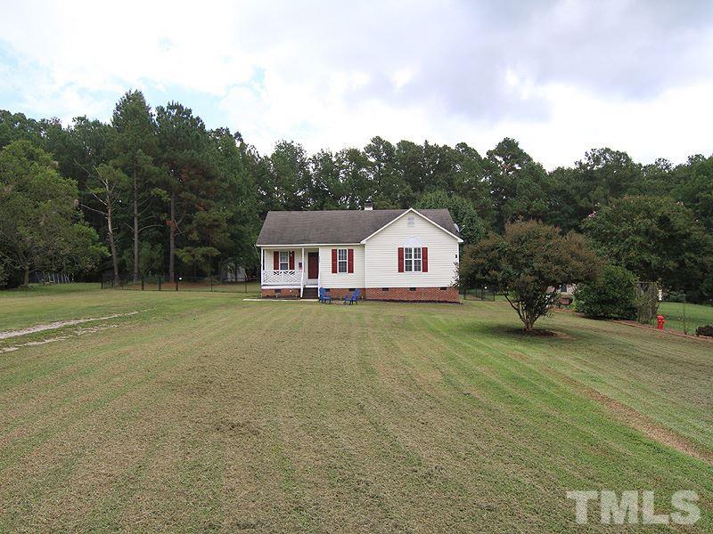 4009 Rockside Hills Drive Raleigh, NC 27603 - Photo 2 of 25 a front view of a house with garden