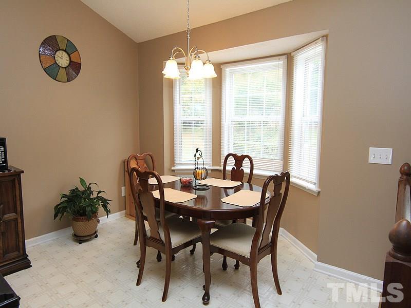 4009 Rockside Hills Drive Raleigh, NC 27603 - Photo 12 of 25 a view of a dining room with furniture and chandelier