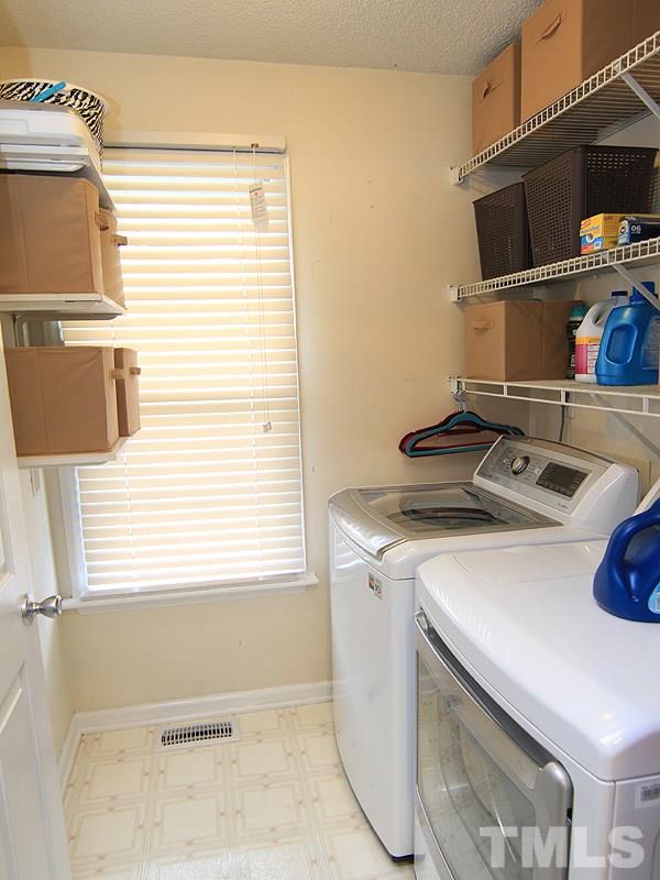 4009 Rockside Hills Drive Raleigh, NC 27603 - Photo 14 of 25 a utility room with dryer and washer