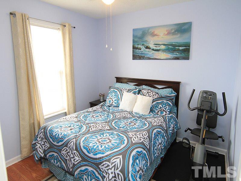 4009 Rockside Hills Drive Raleigh, NC 27603 - Photo 15 of 25 a bedroom with bed and wooden floor