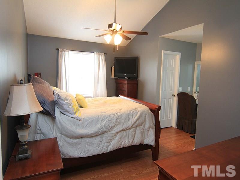 4009 Rockside Hills Drive Raleigh, NC 27603 - Photo 16 of 25 a bed room with a bed window and a chair