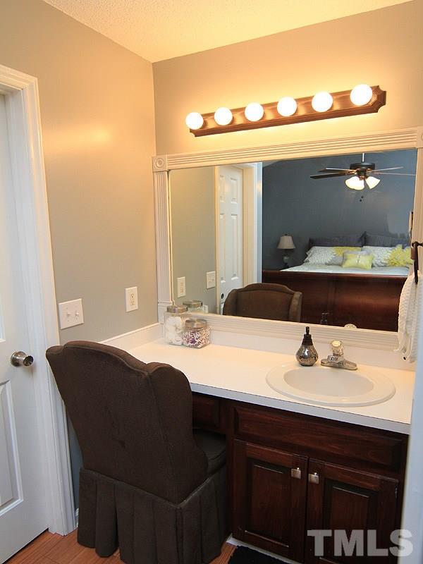 4009 Rockside Hills Drive Raleigh, NC 27603 - Photo 19 of 25 a bathroom with a sink and a mirror