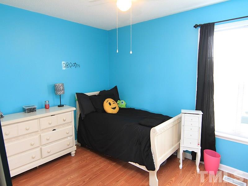4009 Rockside Hills Drive Raleigh, NC 27603 - Photo 20 of 25 a bedroom with a bed and a dresser