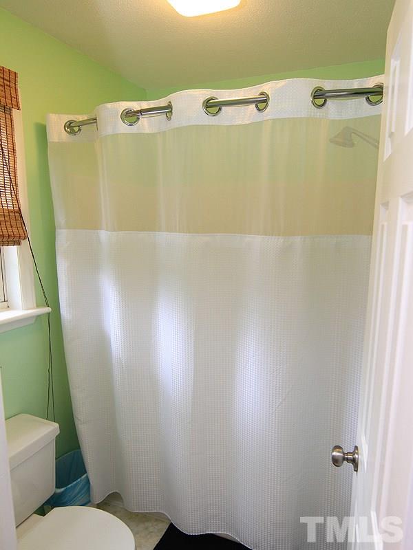 4009 Rockside Hills Drive Raleigh, NC 27603 - Photo 21 of 25 a bathroom with a sink mirror vanity and toilet
