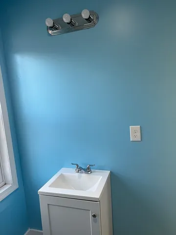 a bathroom with a sink toilet and mirror