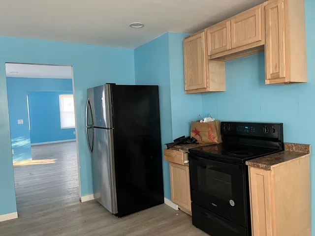 a kitchen with a refrigerator and a cabinets