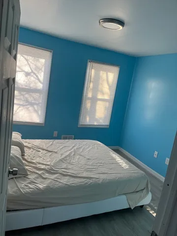 a bedroom with a bed and window
