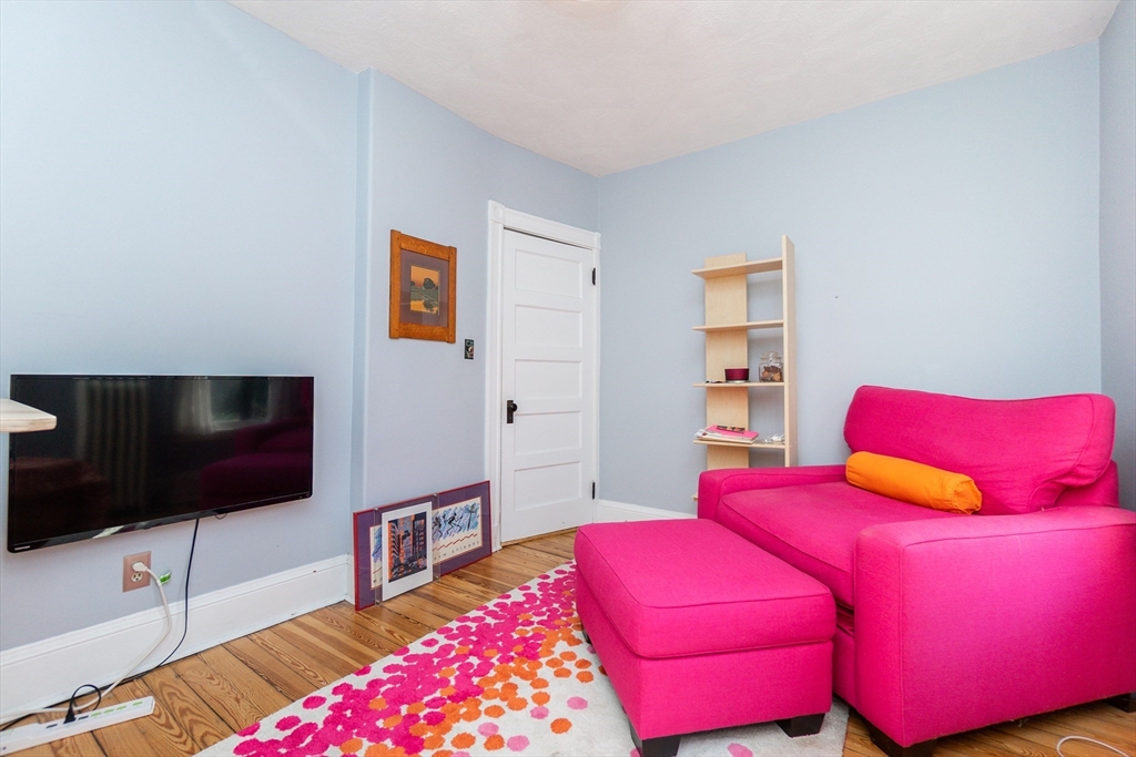 25 Eustis Street, Unit 1 Cambridge, MA 02140 - Photo 7 of 14 a living room with a bed and a flat screen tv