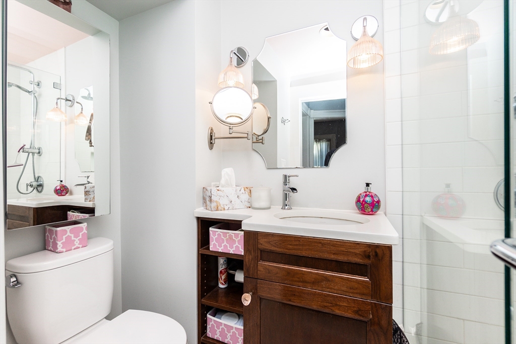 25 Eustis Street, Unit 1 Cambridge, MA 02140 - Photo 10 of 14 a bathroom with a sink vanity mirror and toilet