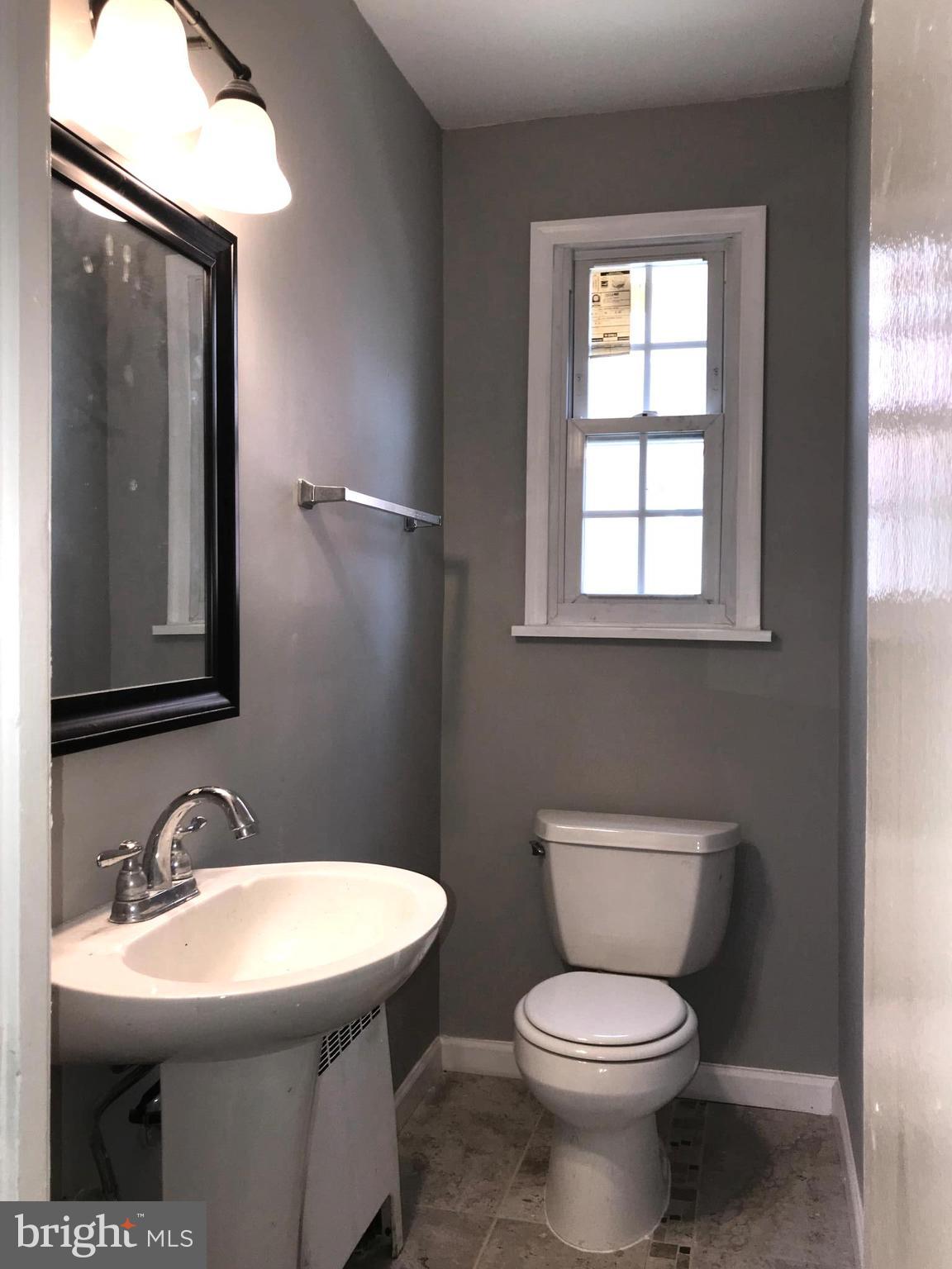 7900 Riggs Road Hyattsville, MD 20783 - Photo 9 of 9 a bathroom with a toilet sink and mirror