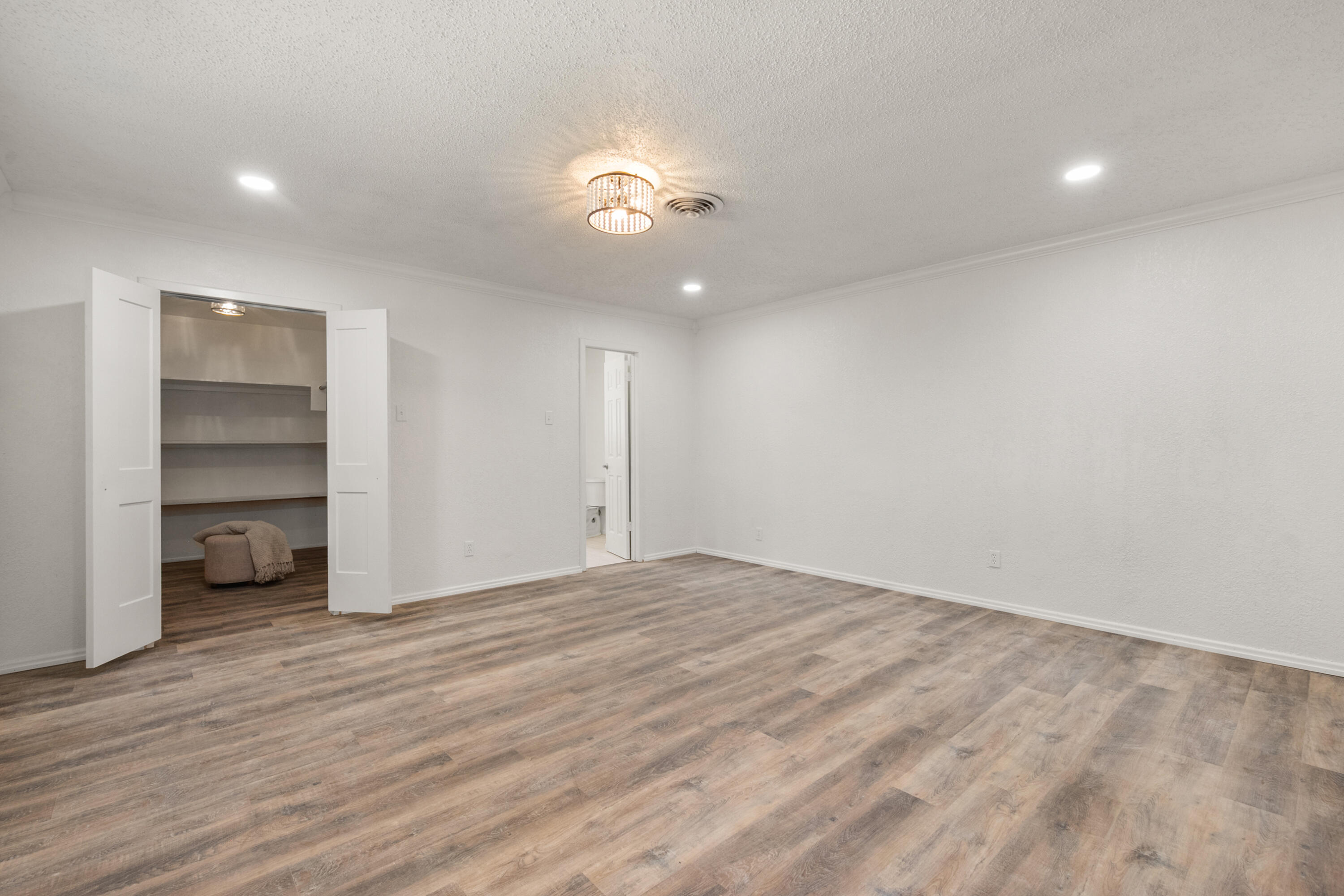816 Cedar Street Floydada, TX 79235 - Photo 14 of 24 a view of an empty room with a window and wooden floor