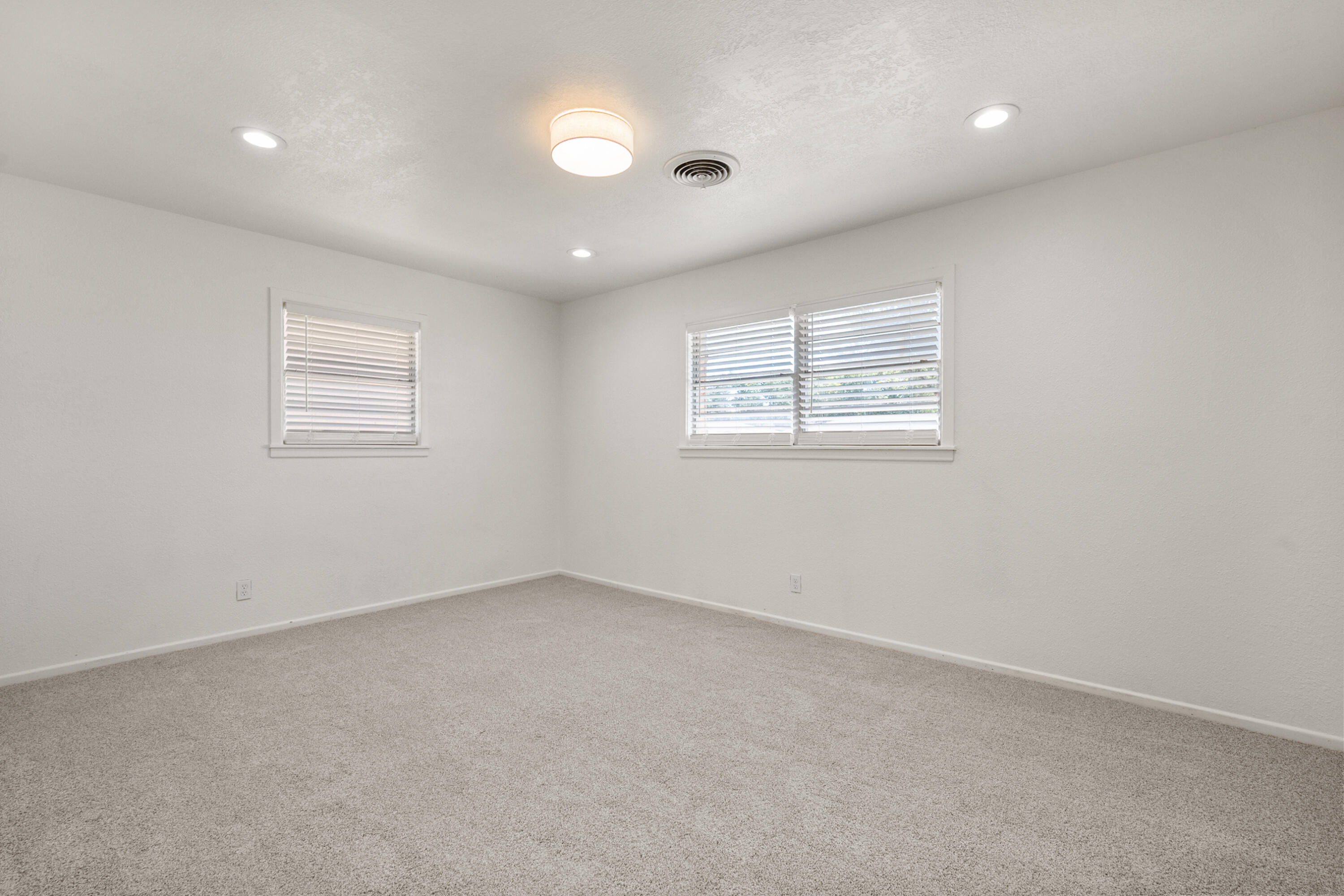 816 Cedar Street Floydada, TX 79235 - Photo 19 of 24 an empty room with windows