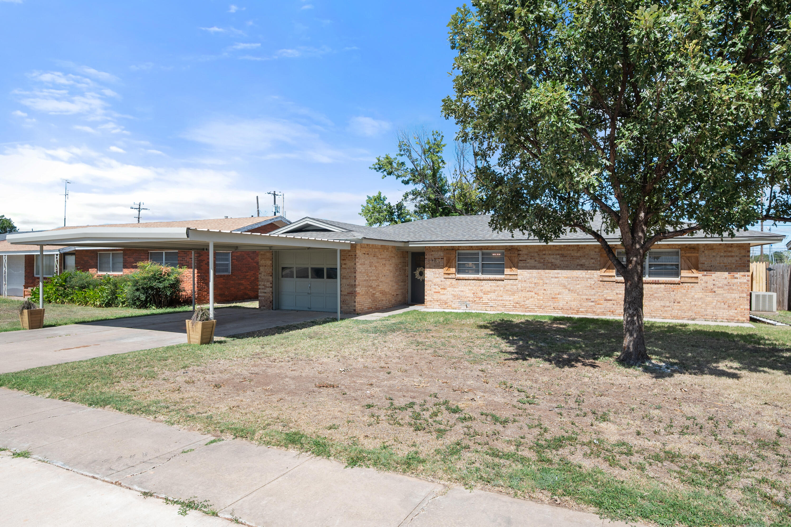 816 Cedar Street Floydada, TX 79235 - Photo 2 of 24 a view of a house with backyard and a tree