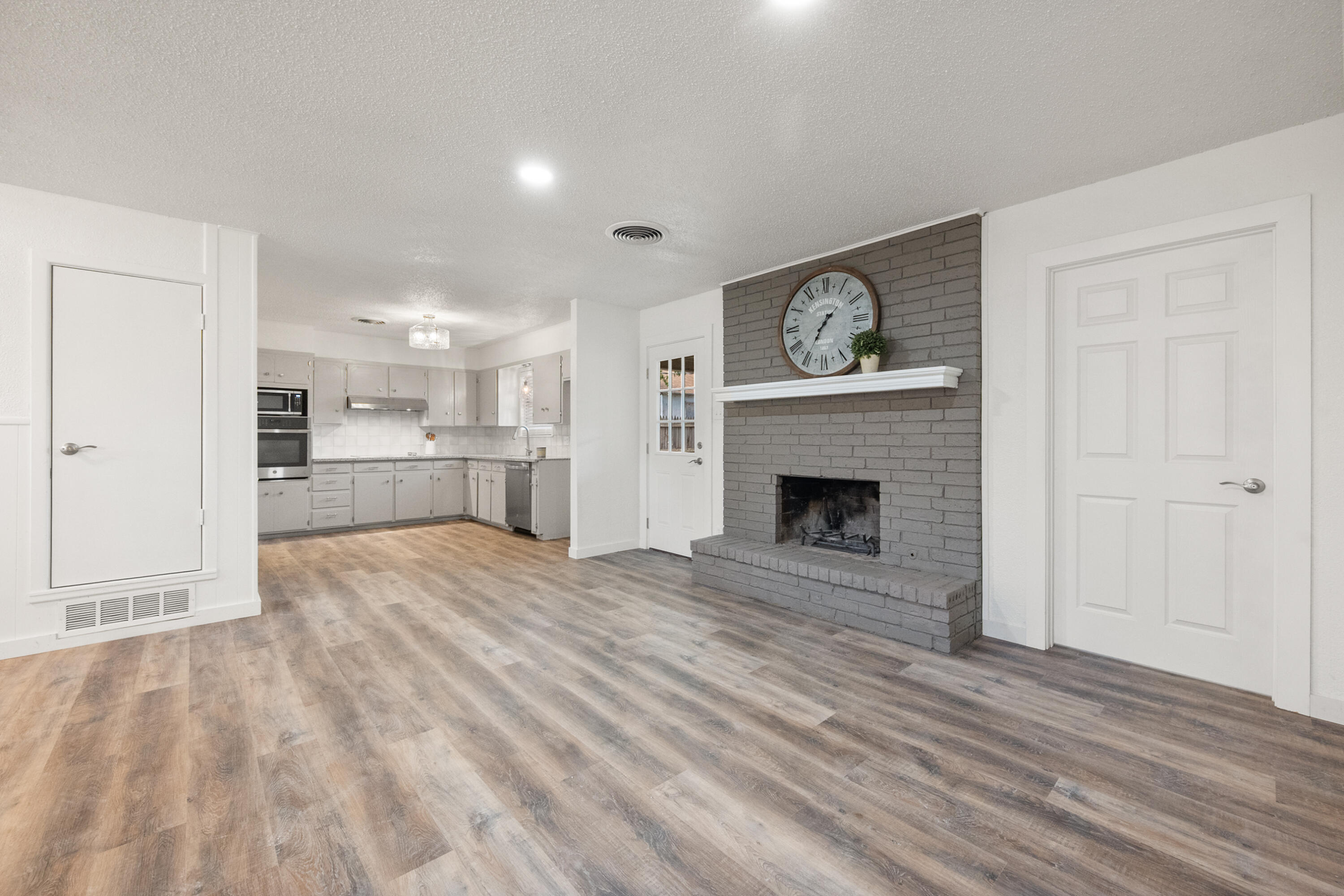 816 Cedar Street Floydada, TX 79235 - Photo 4 of 24 a open kitchen view with fireplace and wooden floor