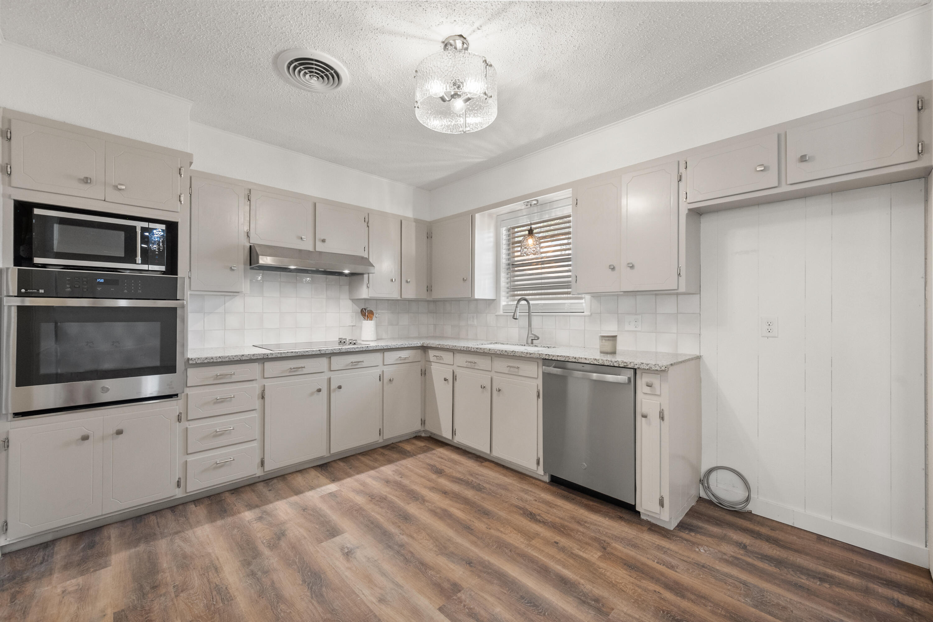 816 Cedar Street Floydada, TX 79235 - Photo 9 of 24 a kitchen with stainless steel appliances granite countertop a sink and cabinets