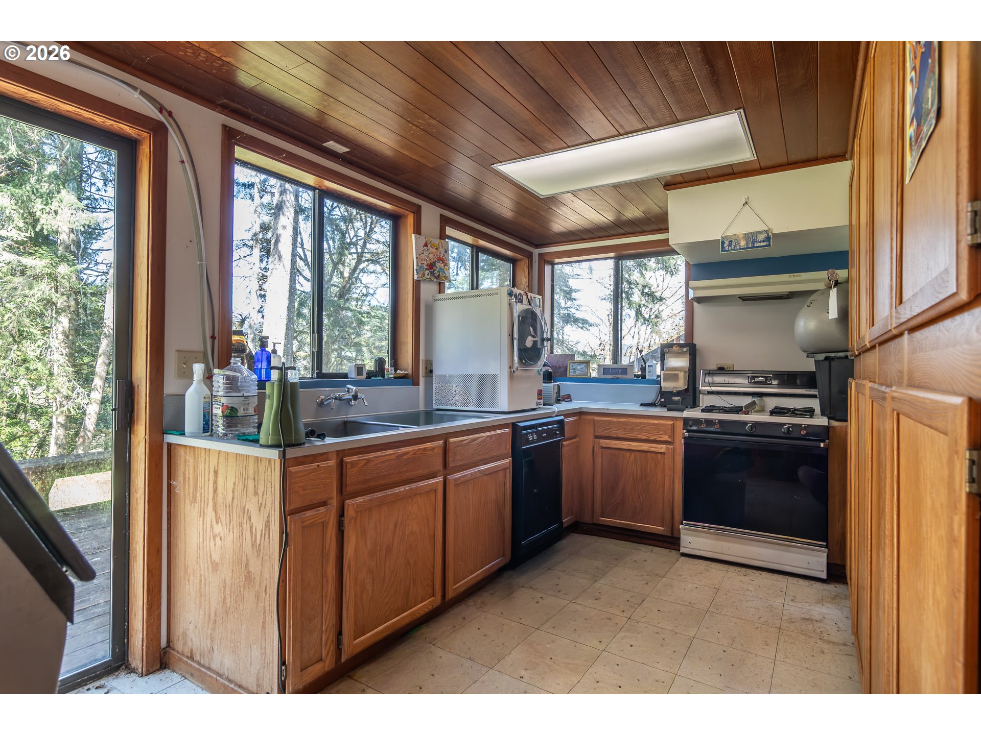 4890 Henderer Road Elkton, OR 97436 - Photo 27 of 48 a kitchen with granite countertop a stove a sink and a refrigerator