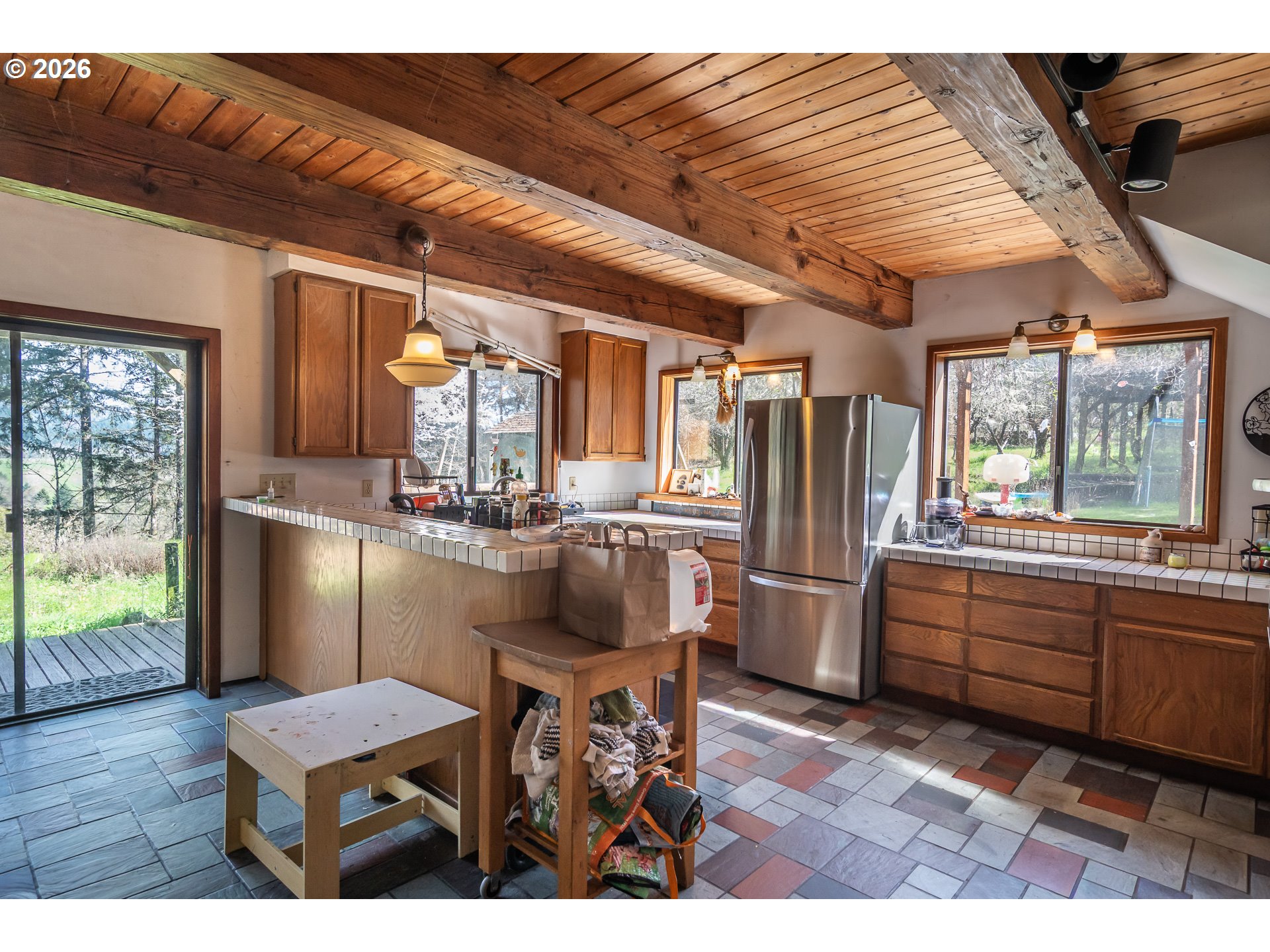 4890 Henderer Road Elkton, OR 97436 - Photo 4 of 48 a kitchen with refrigerator and chairs