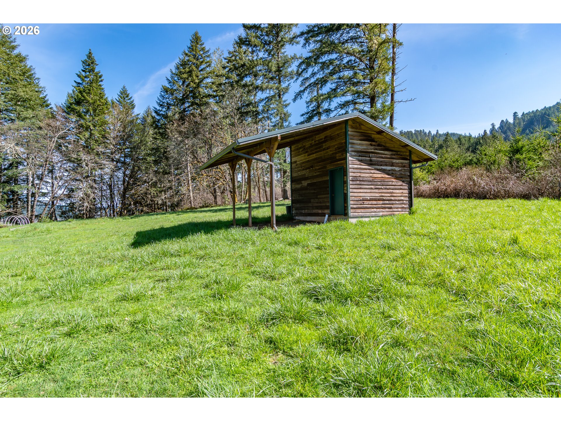 4890 Henderer Road Elkton, OR 97436 - Photo 44 of 48 a backyard of a house with lots of green space
