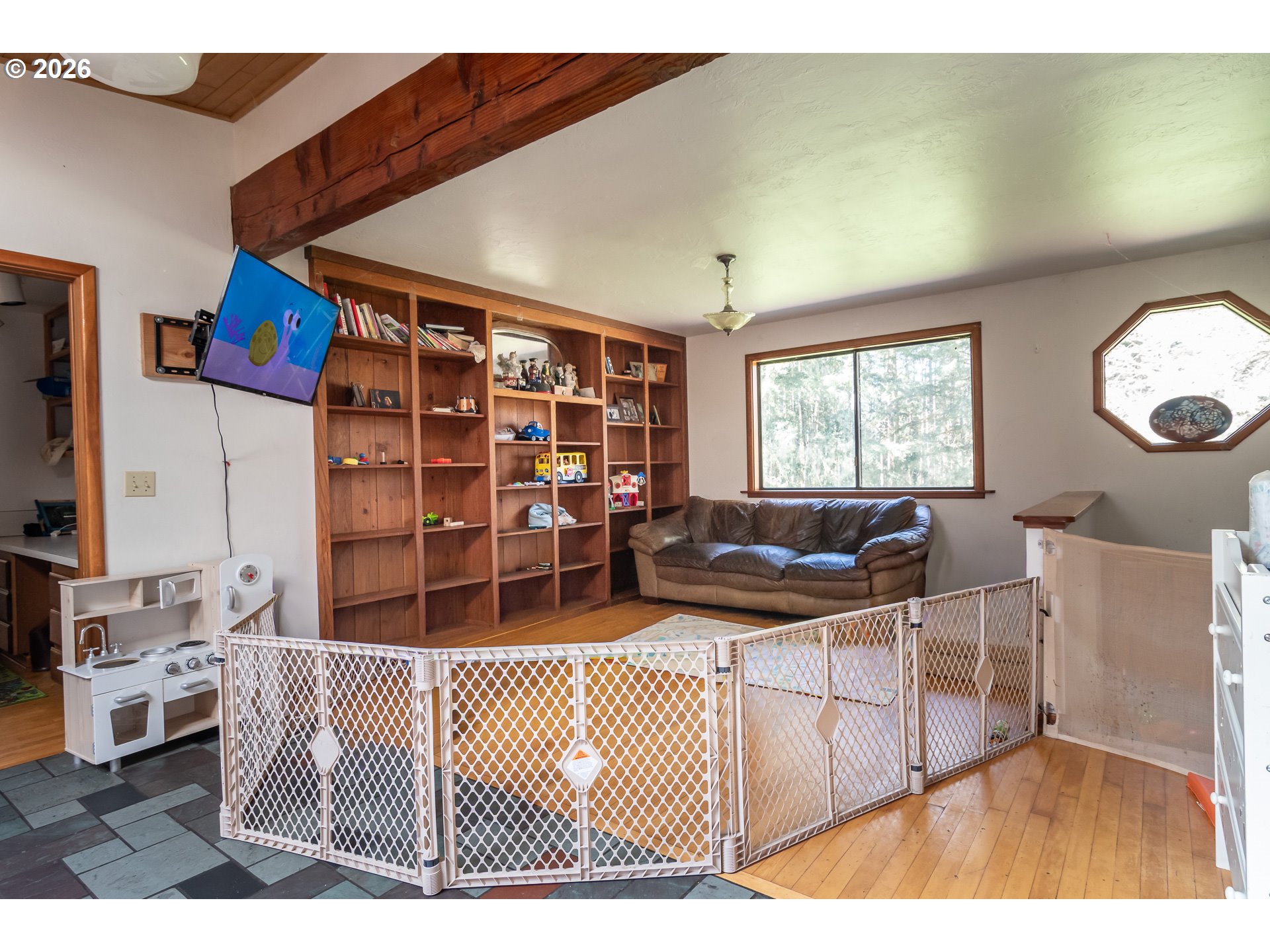 4890 Henderer Road Elkton, OR 97436 - Photo 8 of 48 a living room with furniture a flat screen tv and a table