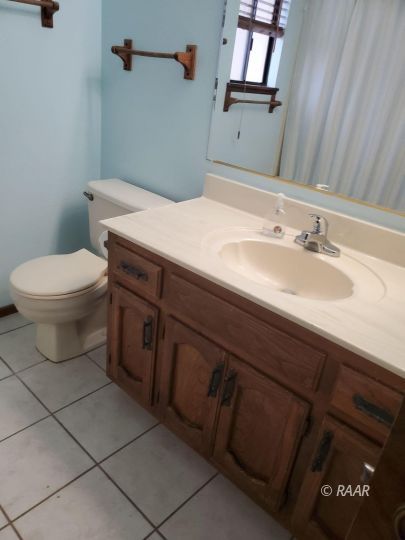 342 East Wilson Avenue Ridgecrest, CA 93555 - Photo 16 of 27 a bathroom with a sink a toilet and mirror