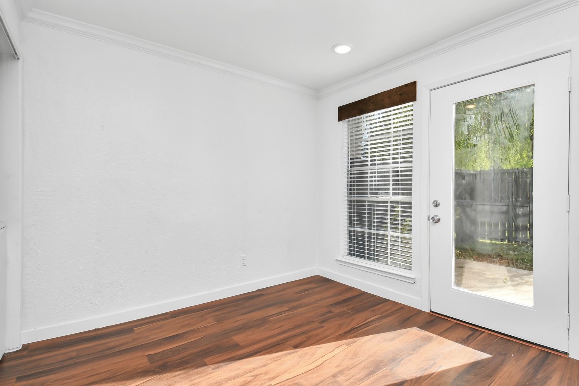 2002 Gentryside Drive, Unit 113 Houston, TX 77077 - Photo 11 of 36 a view of an empty room with wooden floor and a window