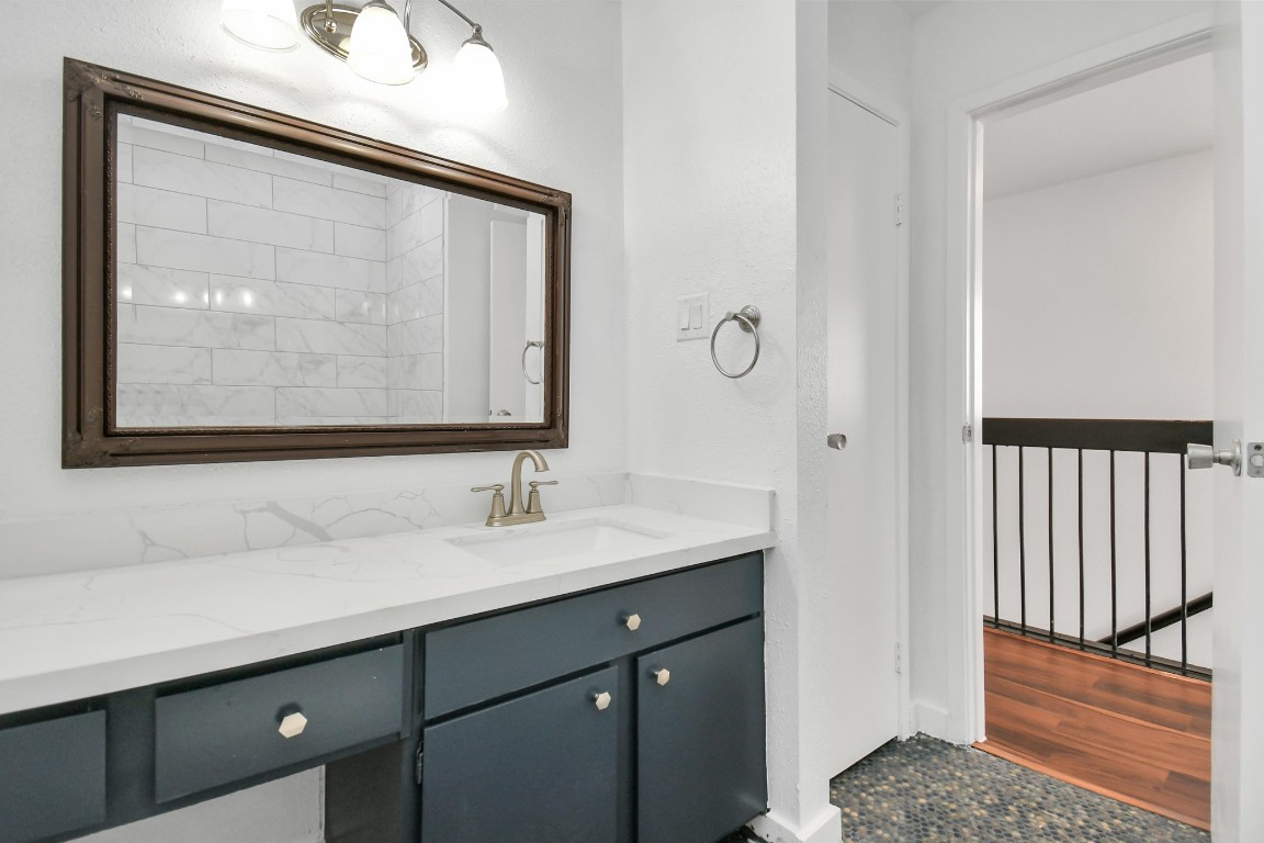 2002 Gentryside Drive, Unit 113 Houston, TX 77077 - Photo 20 of 36 a bathroom with a sink a vanity and a mirror