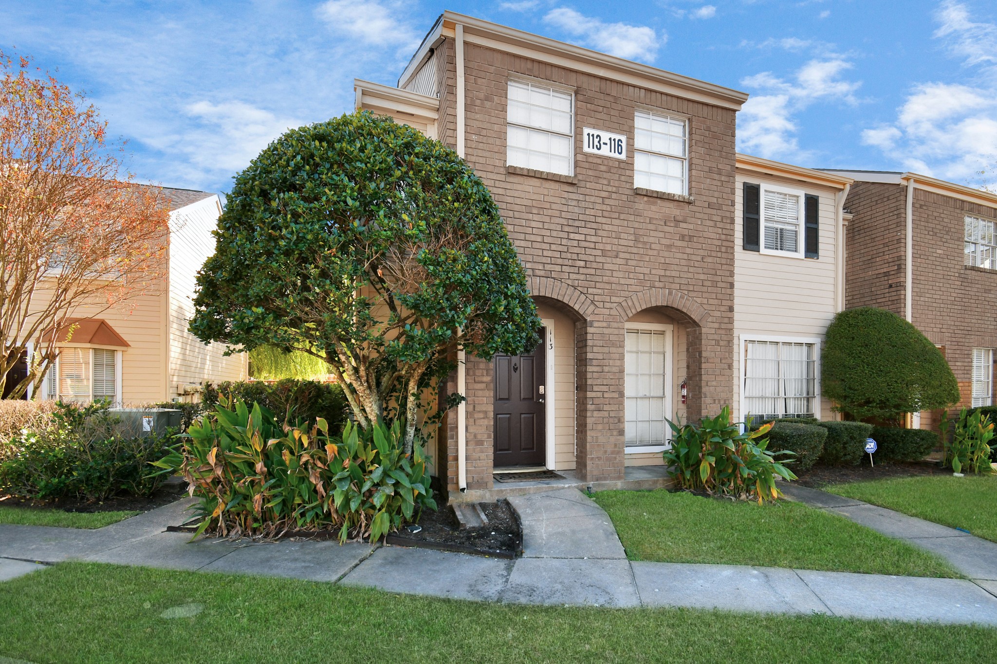 2002 Gentryside Drive, Unit 113 Houston, TX 77077 - Photo 2 of 36 a front view of a house with garden