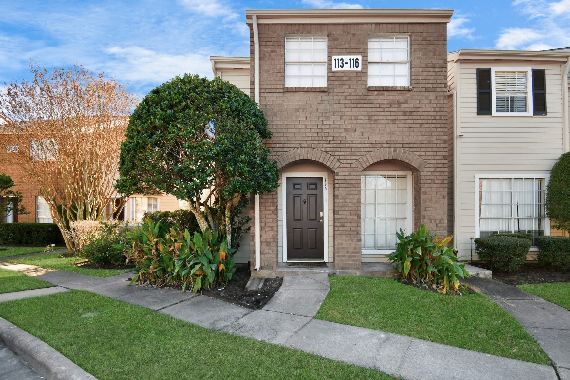 2002 Gentryside Drive, Unit 113 Houston, TX 77077 - Photo 32 of 36 a front view of a house with garden