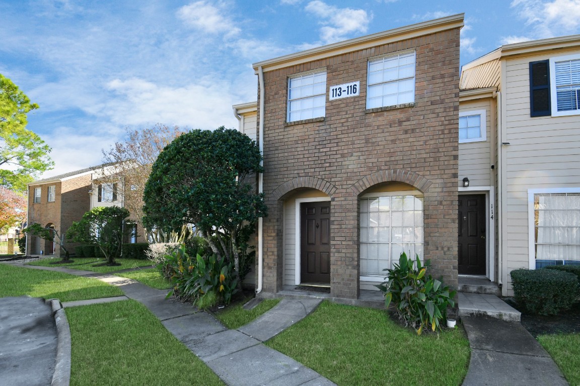2002 Gentryside Drive, Unit 113 Houston, TX 77077 - Photo 33 of 36 a front view of a house with garden