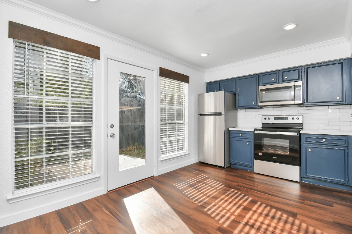 2002 Gentryside Drive, Unit 113 Houston, TX 77077 - Photo 6 of 36 a kitchen with stainless steel appliances a refrigerator and a stove top oven