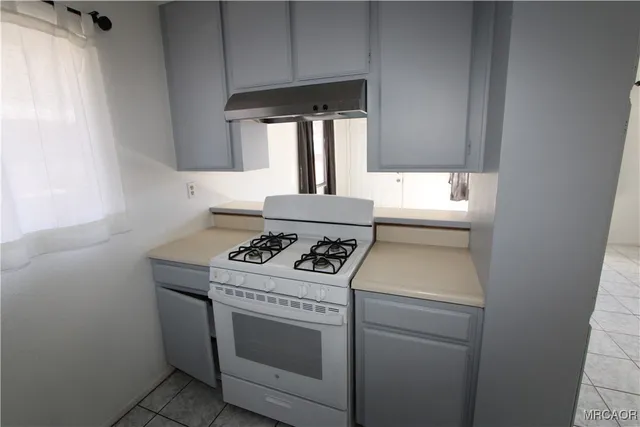 a stove top oven sitting inside of a kitchen