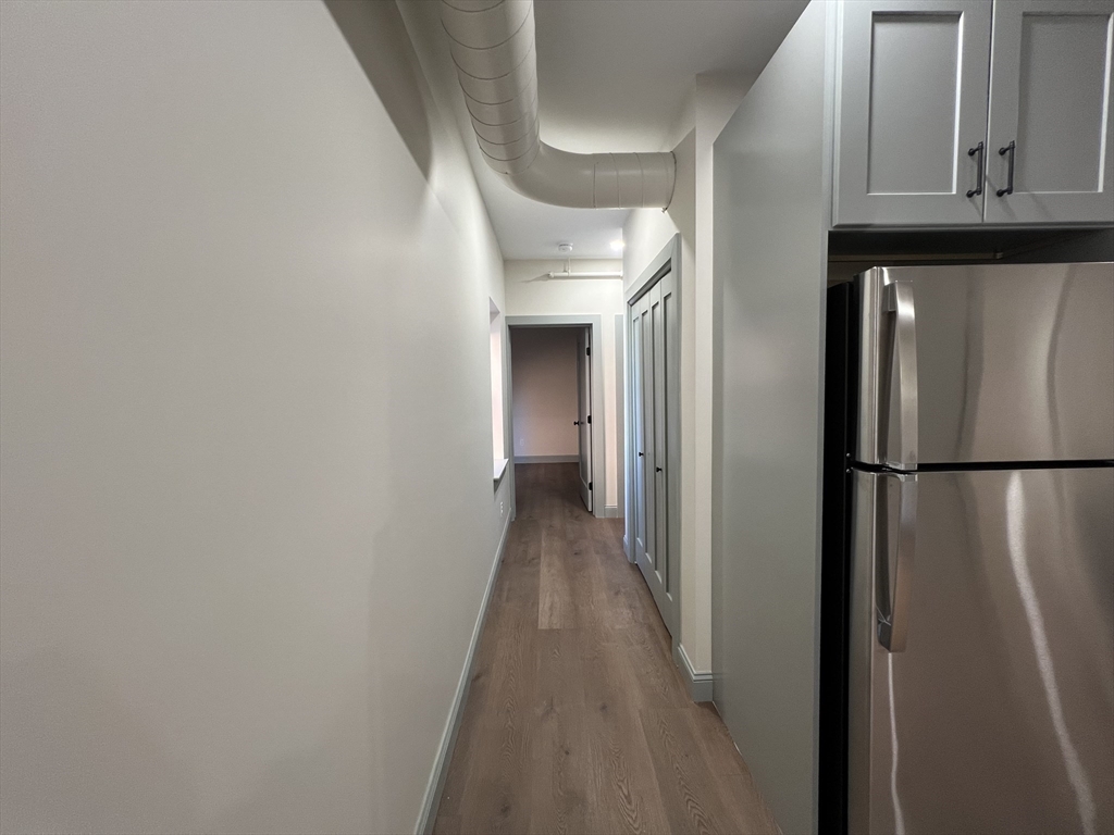 160 Seabury Street, Unit 12 Fall River, MA 02720 - Photo 3 of 11 a view of a hallway with wooden floor and staircase