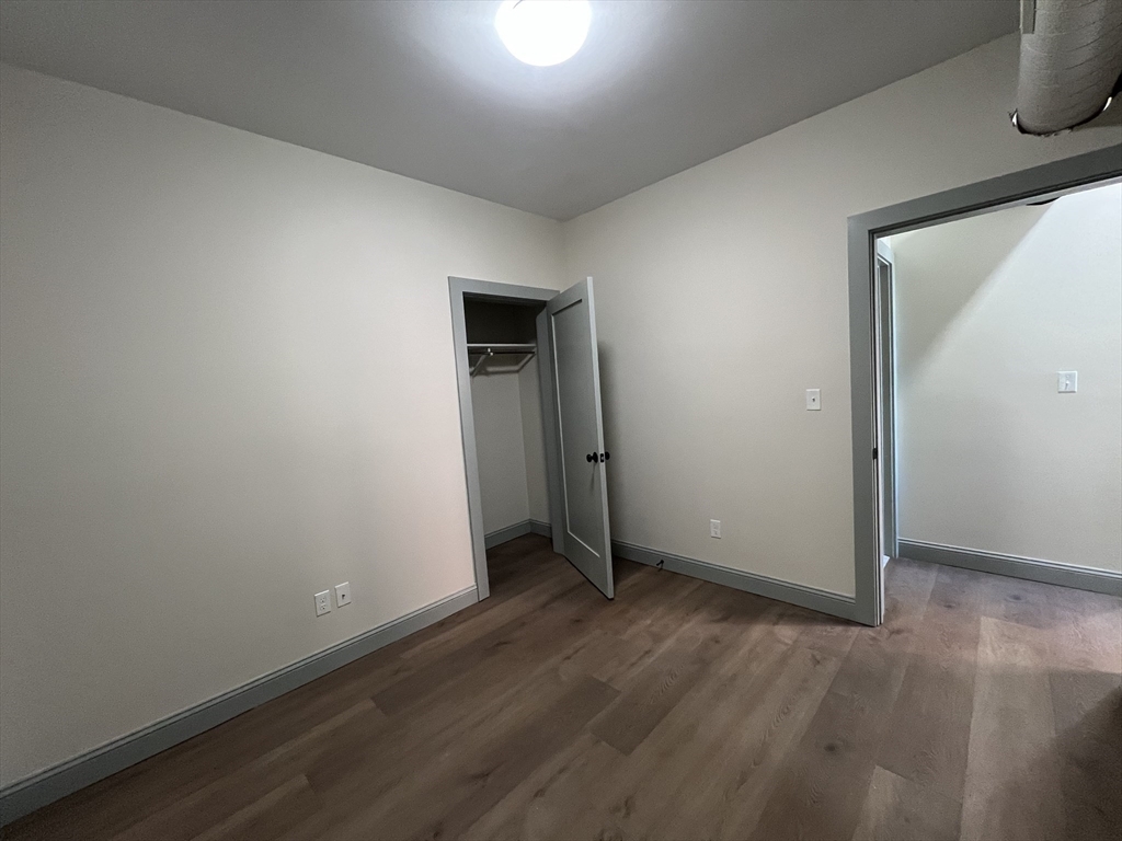 160 Seabury Street, Unit 12 Fall River, MA 02720 - Photo 9 of 11 an empty room with wooden floor and closet