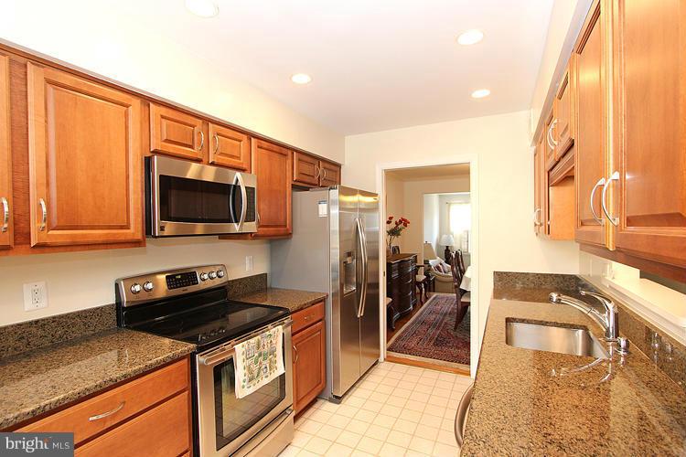 10922 Brewer House Road Rockville, MD 20852 - Photo 13 of 27 a kitchen with stainless steel appliances granite countertop a stove a sink and a microwave
