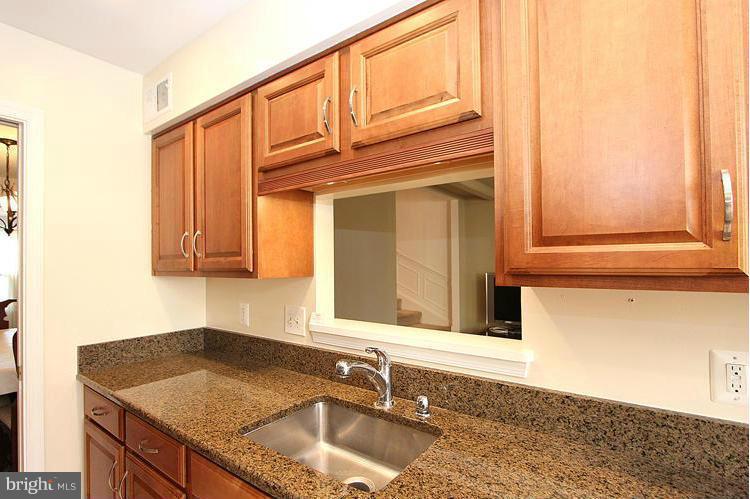10922 Brewer House Road Rockville, MD 20852 - Photo 14 of 27 a bathroom with a granite countertop sink and a window