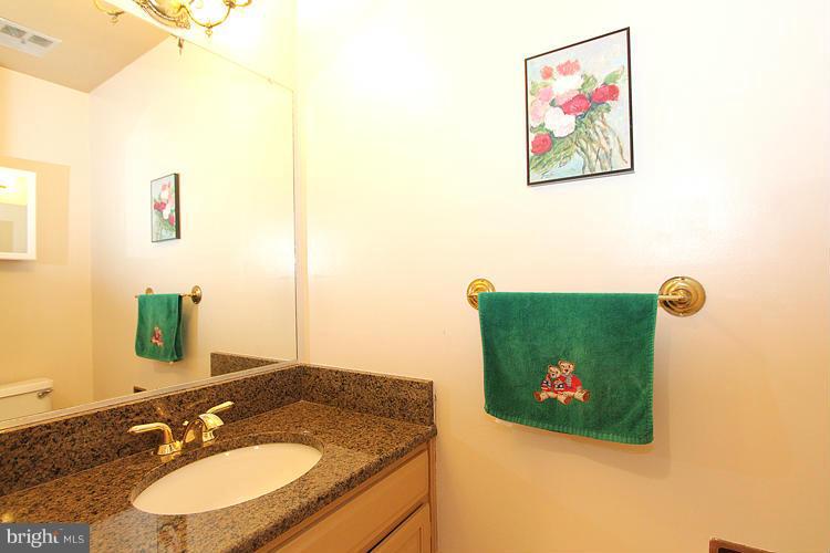 10922 Brewer House Road Rockville, MD 20852 - Photo 15 of 27 a bathroom with a granite countertop sink and a mirror