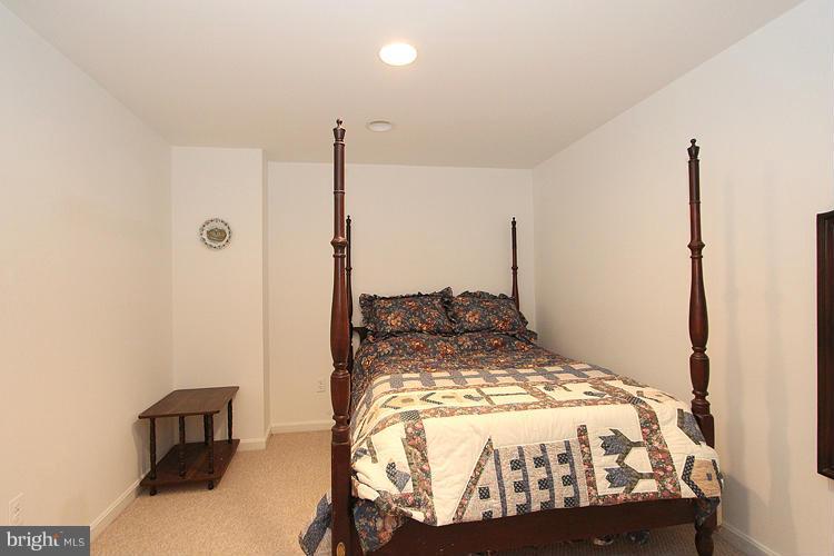 10922 Brewer House Road Rockville, MD 20852 - Photo 17 of 27 a bed sitting in a bedroom next to a window