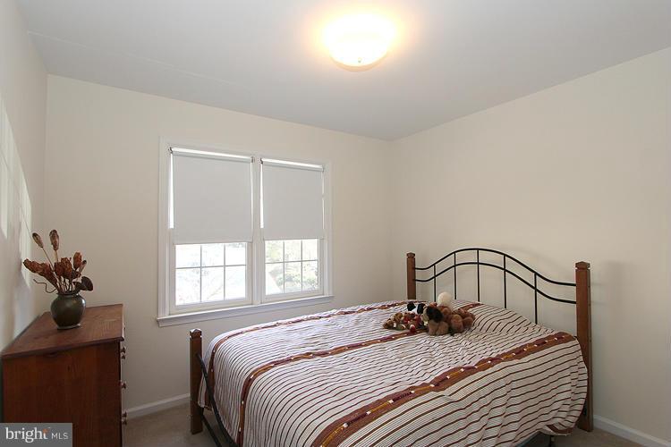 10922 Brewer House Road Rockville, MD 20852 - Photo 18 of 27 a bedroom with a bed and window