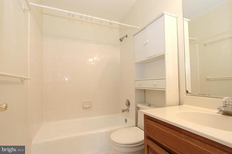 10922 Brewer House Road Rockville, MD 20852 - Photo 22 of 27 a bathroom with a granite countertop sink toilet and shower