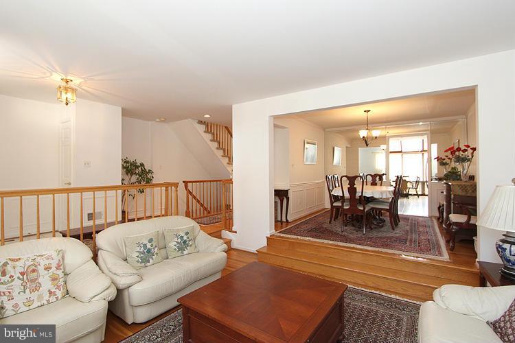 10922 Brewer House Road Rockville, MD 20852 - Photo 6 of 27 a living room with furniture and a dining table with wooden floor